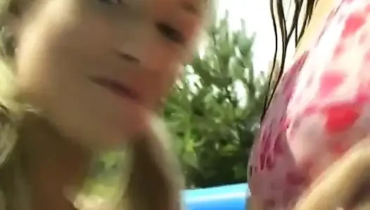 Lesbians have fun with a dildo at pool party