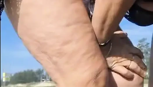 Hot crown sunbathing on the beach in transparent micro bikini