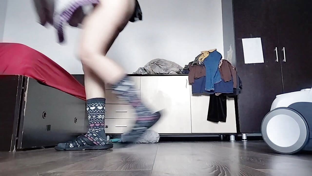 Amateur mom cleans naked with vacuum cleaner in the house.