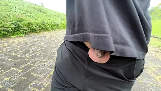 A young boy with a small foreskin exposes himself in the woods