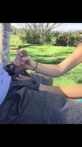 She jerks him on the green field