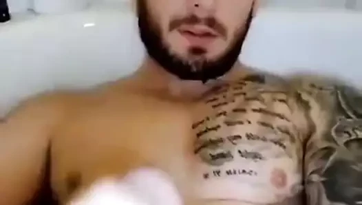 The guy jerks his dick and cums in the tub