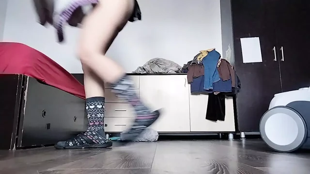 Amateur mom cleans naked with vacuum cleaner in the house.