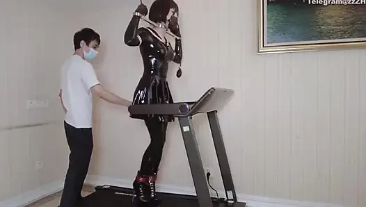 Mz24 - a Girl Bound to a Treadmill with Metal Restraints and Shackles