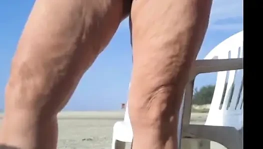 Hot crown sunbathing on the beach in transparent micro bikini