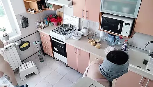 An amateur couple is having fun in the kitchen.