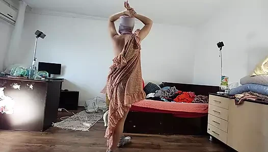 Sexy mom has fun trying on clothes and cutting them.