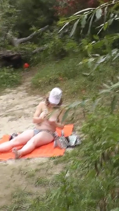 Memorable moment from "Wild beach. Random passerby guy peeps on sunbathing topless beautiful Milf on the river bank"