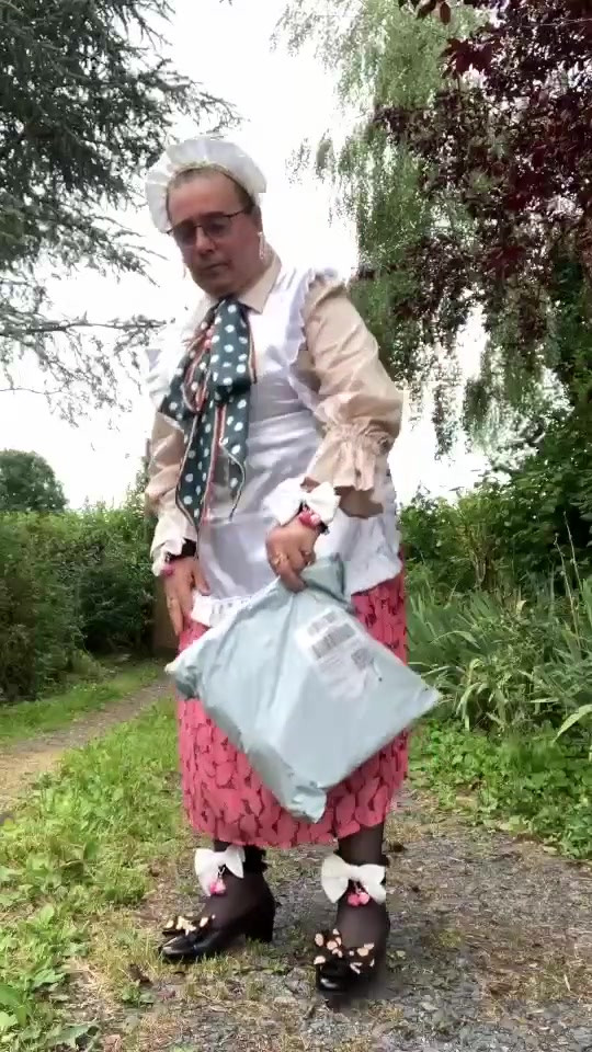 In vintage maid outfit to go pick up a package from the mailbox.