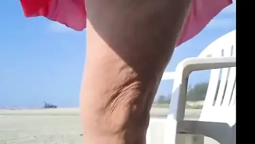 Hot crown sunbathing on the beach in transparent micro bikini