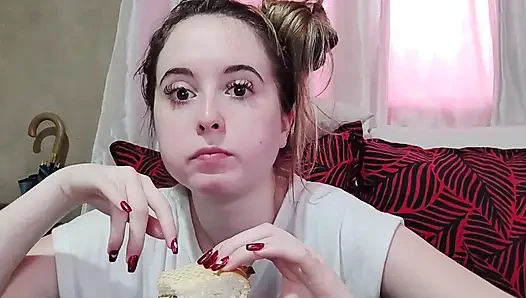 Eating an omelette sandwich with cherry tomatoes