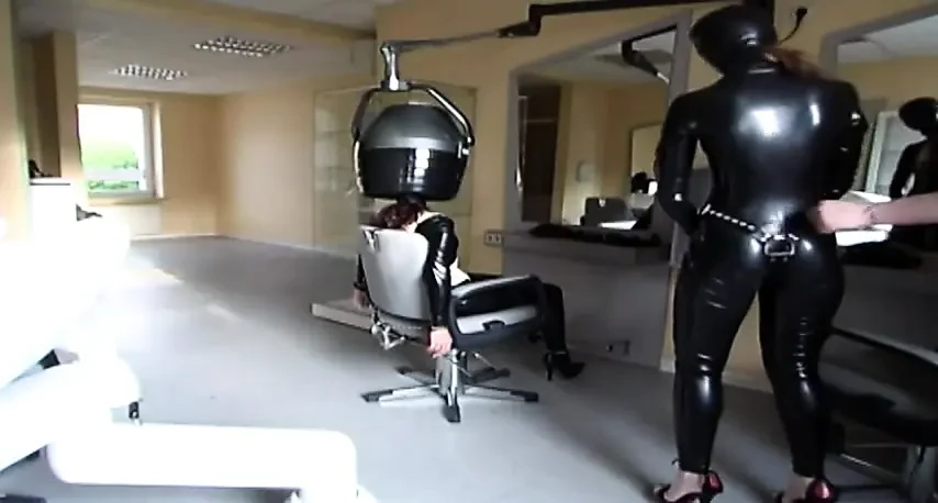 Masked redhead in latex gets tied up