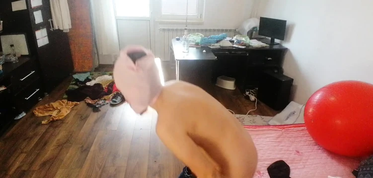 Amateur woman has fun trying on clothes and cutting them.