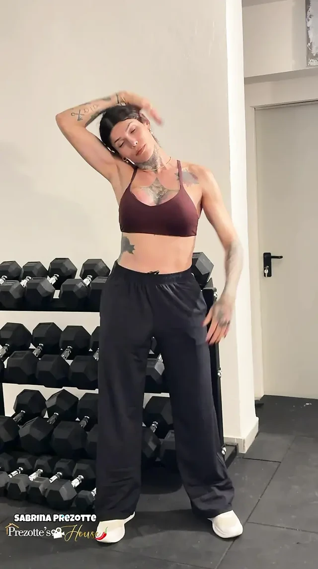 Güzel kız, spor salonunda nasıl antrenman yapılacağını göstererek şehvet yaratıyor.