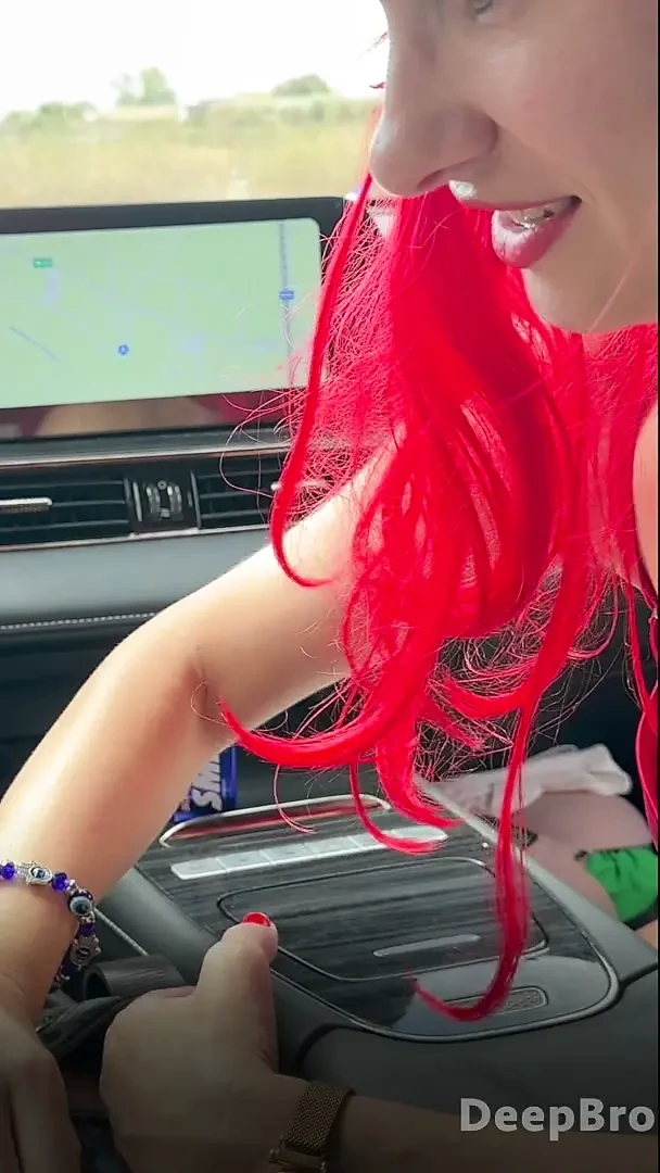 Redhead deepthroats thick BBC in the car, fingers gripping tight