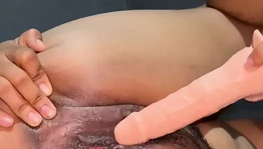 Big, plump hairy pussy trying out sex with a dildo in a sideways position