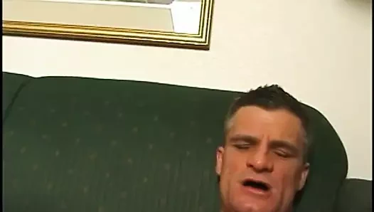 Guy laid on sofa gets dick sucked and guy jerks off