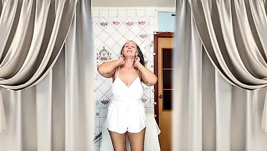 Real home solo of a mature woman in a small cozy kitchen.