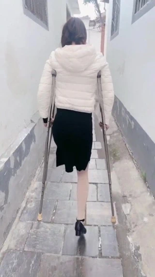 Koltuk değneği üzerinde ampute kız