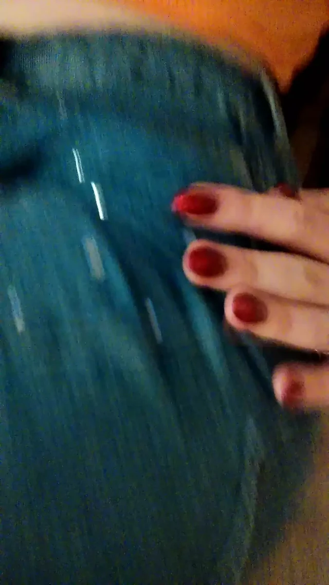 Morning homemade striptease in an orange sweater and jeans. Close-up