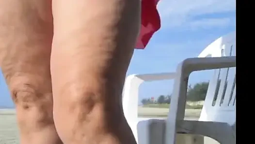Hot crown sunbathing on the beach in transparent micro bikini