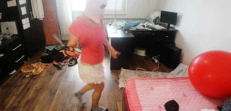 Amateur woman has fun trying on clothes and cutting them.