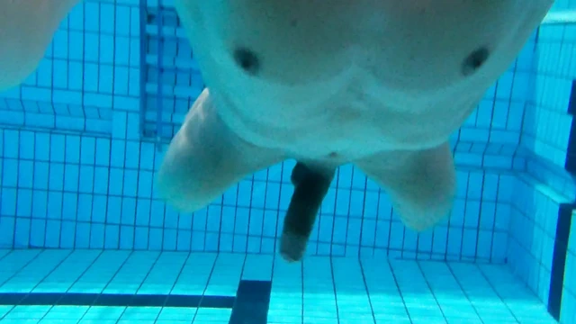 Indoor public pool solo uncut nude fit man swimming