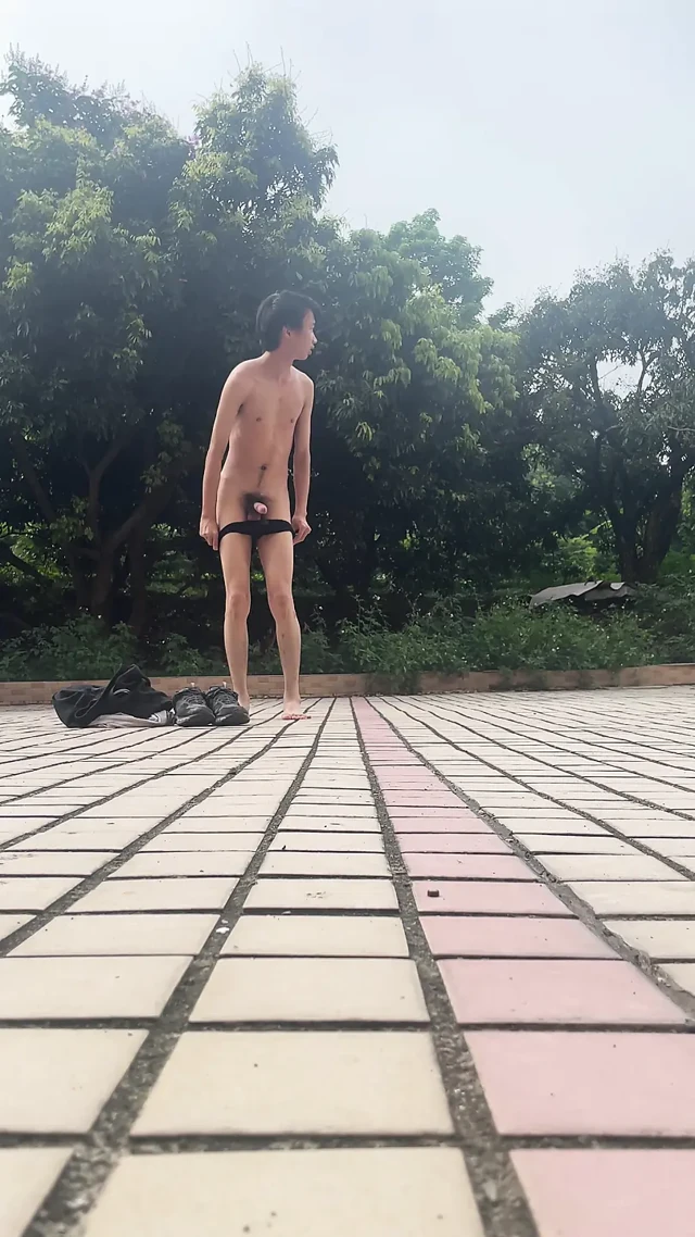 A young man publicly displays his erect penis.