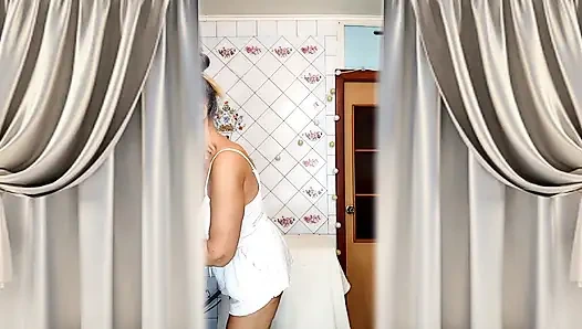 Real home solo of a mature woman in a small cozy kitchen.