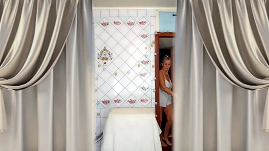 Real home solo of a mature woman in a small cozy kitchen.