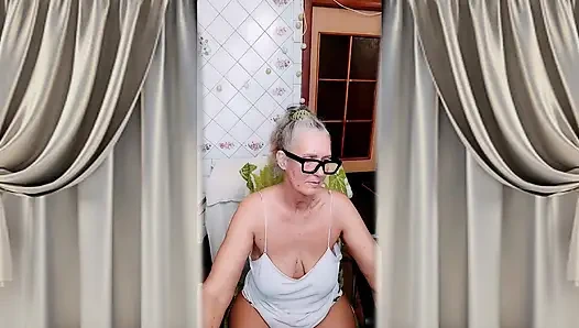 Hot housewife in the kitchen in home clothes.