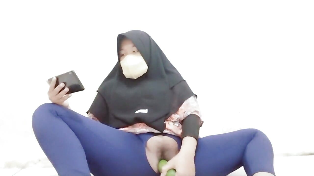 Indonesian hijab aunt wearing cucumber