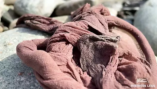 Tanrıça nehir kıyısında yırtık külotlu çorapla dağınık naylon ayaklarını yakın çekim gösteriyor