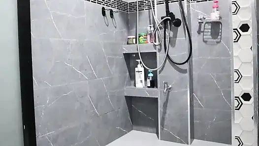 A Thai woman is taking a shower, revealing her pink nipples and smooth, soft vagina while applying body lotion.  Real Thai Solo
