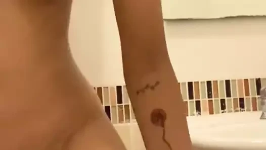 Asyalı kız duş aldıktan sonra losyon koyarak