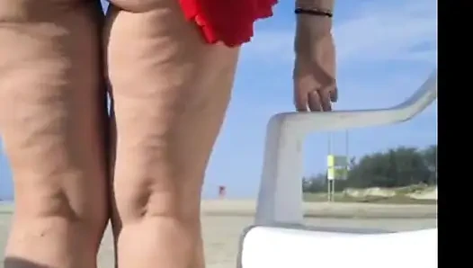 Hot crown sunbathing on the beach in transparent micro bikini