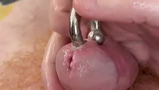Tattooed man plays with pierced cock and cums