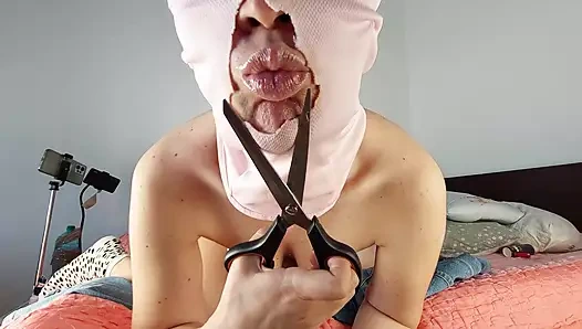 An amateur woman has fun trying on clothes that she cuts. A sexy mom dances naked in the house.