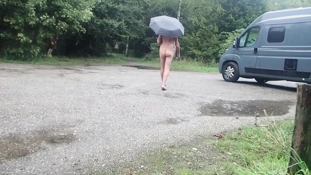 Выставленная обнаженная под дождем с работой сосков на зажимы