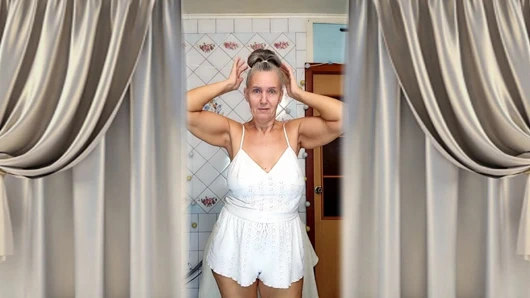 Real home solo of a mature woman in a small cozy kitchen.