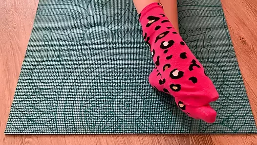 Pembe çoraplı Gloria Gimson yoga minderinde ayaklarını okşuyor