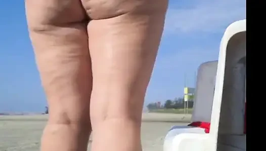 Hot crown sunbathing on the beach in transparent micro bikini