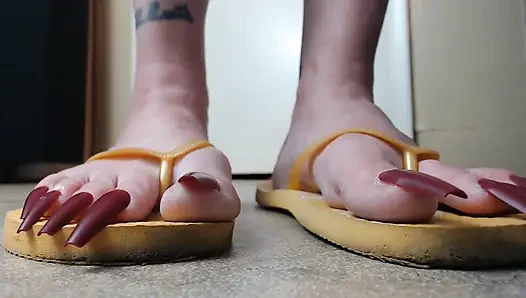 Toenails sarı parmak arası terliklerini sallıyor