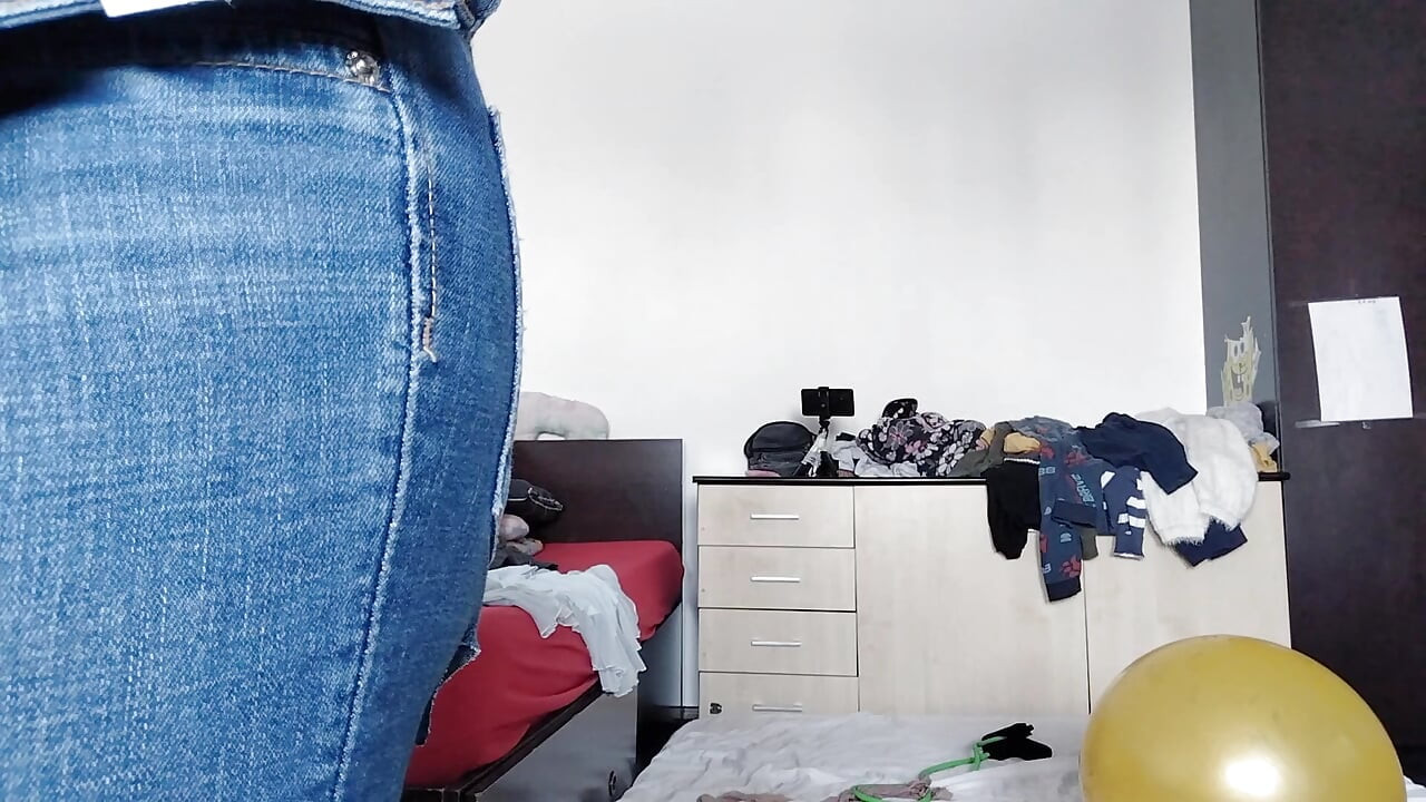 An amateur has fun trying on clothes she has cut. An amateur dances naked in the house.