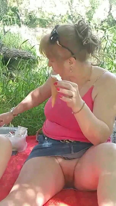 İki kadın olgun orta yaşlı seksi kadın ve eteğinin altında külotsuz genç bakire tatlı dondurma yiyor ve dudaklarını öpüyor açık havada lezbiyenler seks | Klip 1