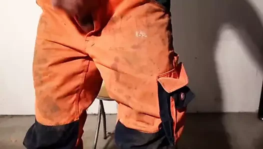 Construction worker squirts on his Hi-Viz worker trousers