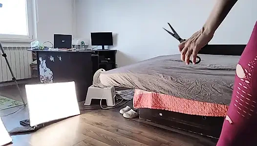 Amateur wife dancing naked at home. Amateur woman has fun trying on clothes and cutting them.