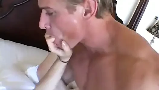 Horny stud licks brunette's feet then fucks her in bed