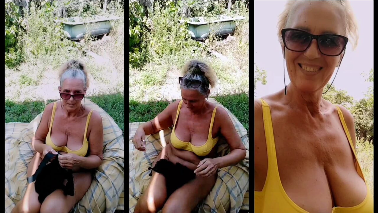 Hot housewife Lukerya in the fresh air in the summer in the yard.