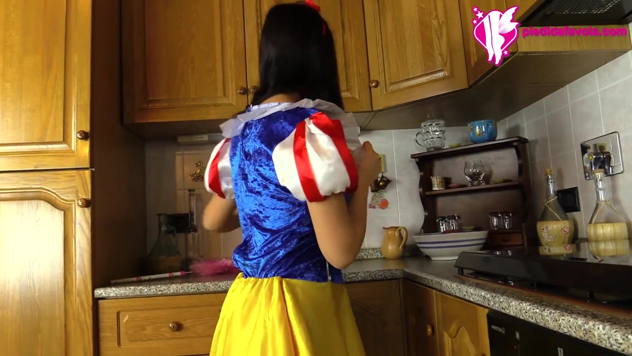 Hot brunette dressed as snow-white massages her feet